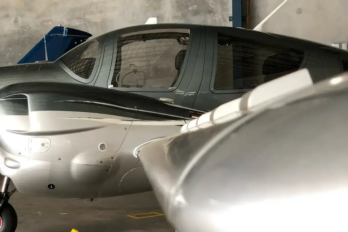 The cabin windows and nose of a Diamond DA62 in a hangar